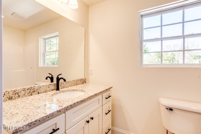 bathroom featuring vanity and toilet