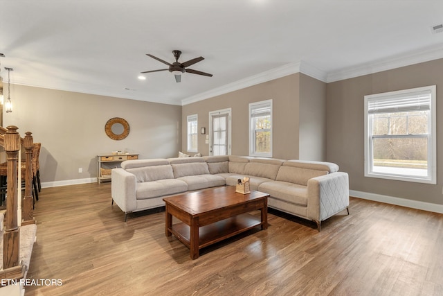 living room featuring ceiling fan, light hardwood / wood-style flooring, and ornamental molding