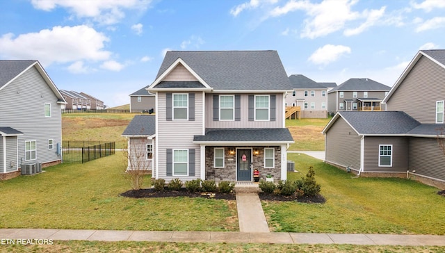 view of front of property with a front lawn and central AC unit