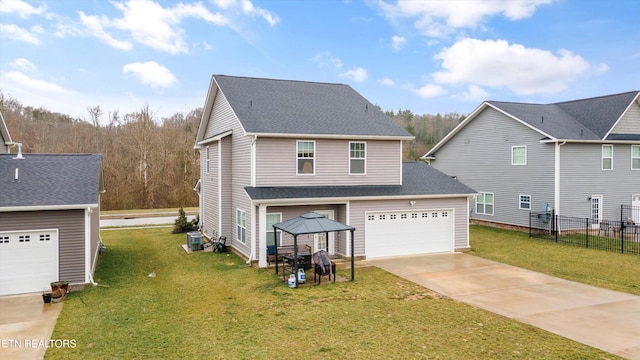 view of front of property featuring a gazebo, cooling unit, a front yard, and a garage