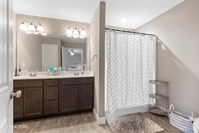 bathroom featuring wood-type flooring, vanity, and curtained shower