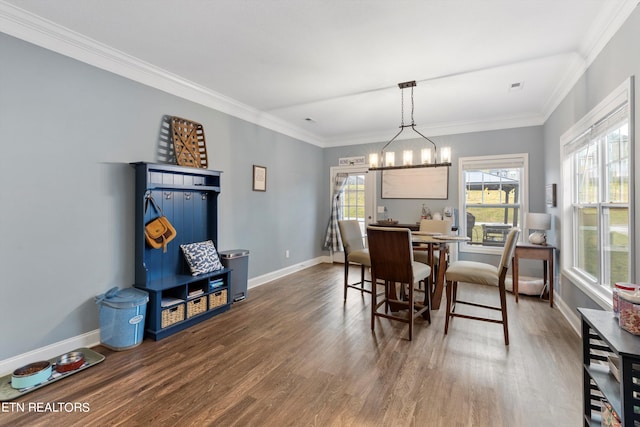 dining room featuring crown molding, hardwood / wood-style floors, and a notable chandelier