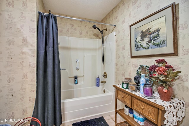 bathroom with tile patterned flooring, a textured ceiling, shower / bath combination with curtain, and wallpapered walls