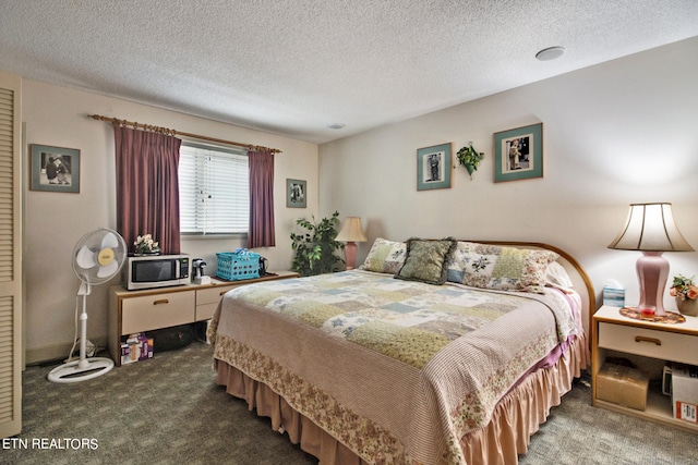 bedroom featuring carpet and a textured ceiling