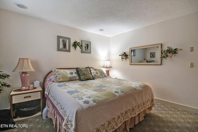 bedroom with carpet floors, a textured ceiling, and baseboards