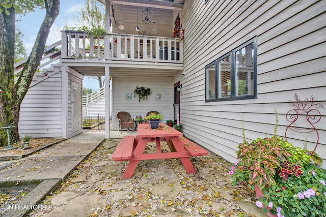 view of patio featuring a balcony