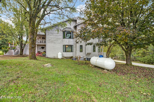 back of house with a lawn