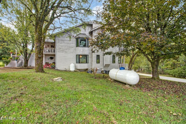 back of property with a lawn