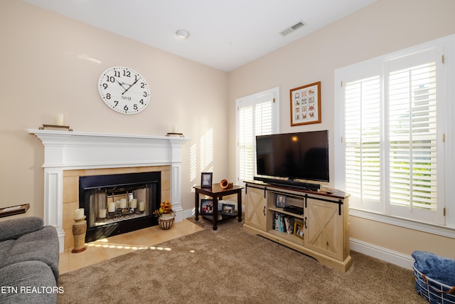 carpeted living room with a fireplace