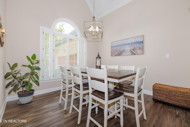 dining area with dark wood-type flooring, high vaulted ceiling, and a chandelier