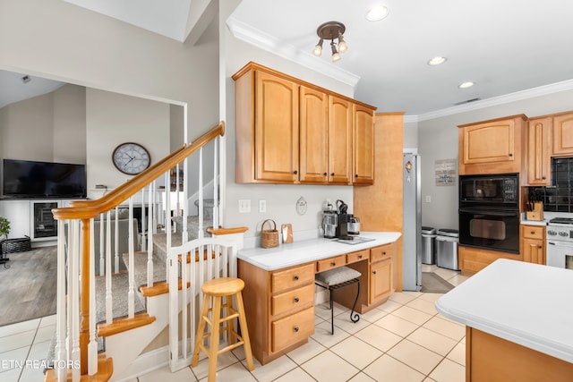 kitchen featuring black appliances, crown molding, decorative backsplash, light tile patterned floors, and light brown cabinets