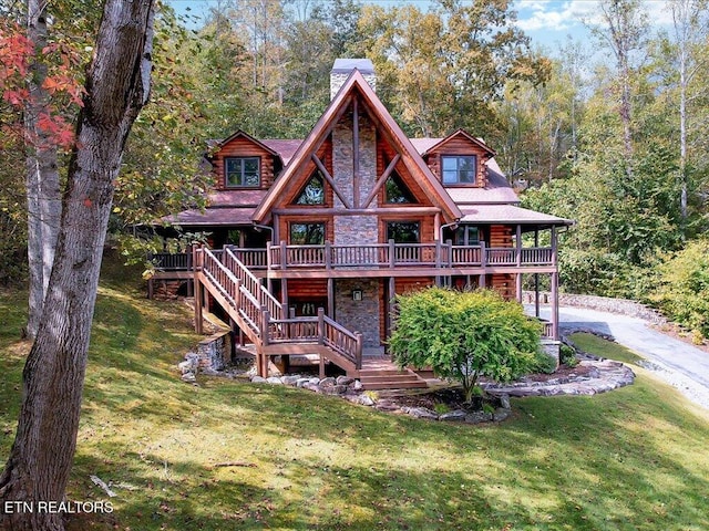 back of property featuring a yard and a deck