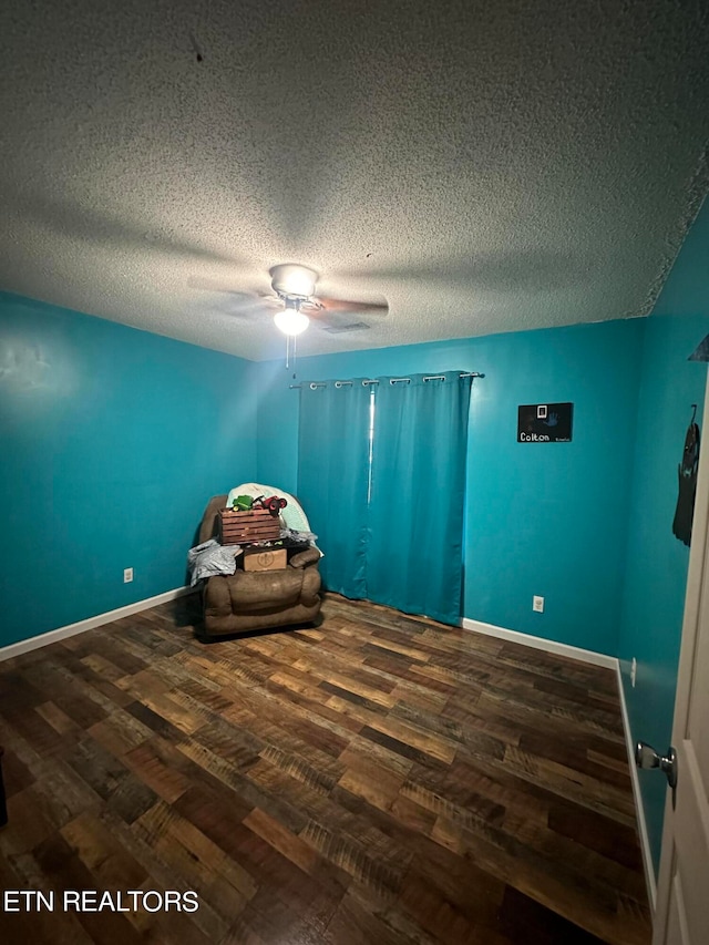 unfurnished bedroom featuring hardwood / wood-style floors, a textured ceiling, and ceiling fan