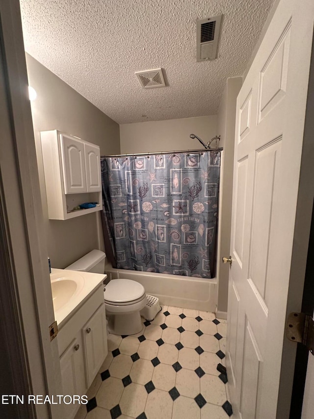 full bathroom with vanity, shower / tub combo, a textured ceiling, and toilet