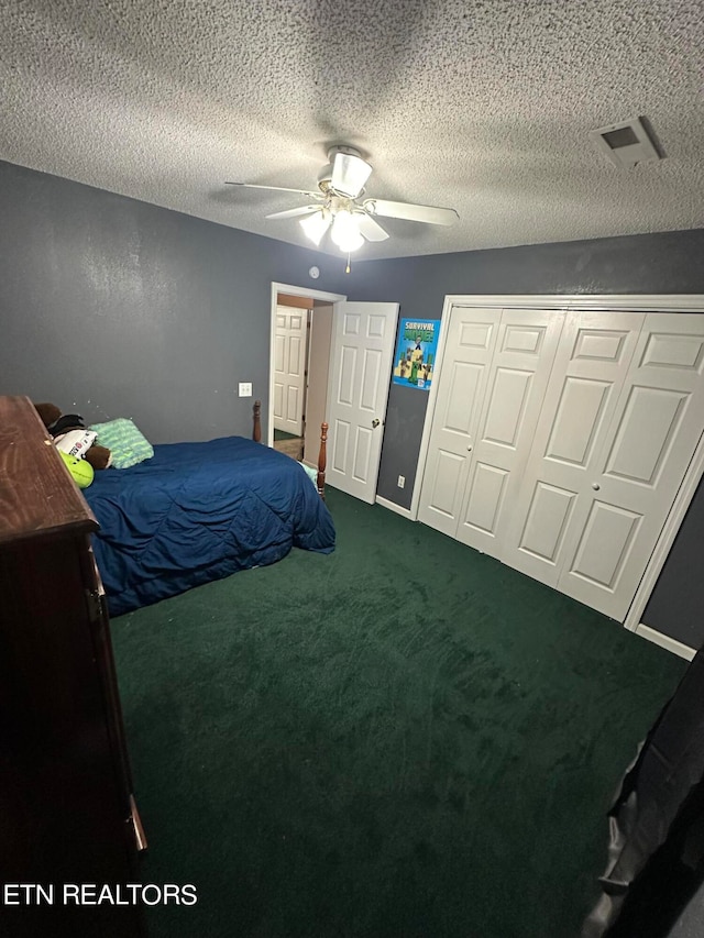 carpeted bedroom with a closet, ceiling fan, and a textured ceiling