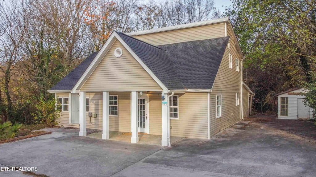 view of front facade featuring covered porch and a storage unit