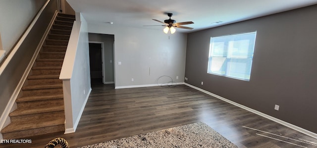 unfurnished living room featuring ceiling fan and dark hardwood / wood-style flooring