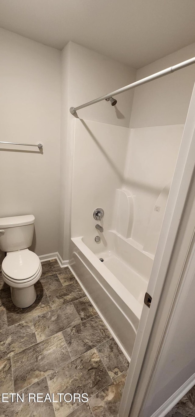 bathroom featuring shower / bathing tub combination and toilet