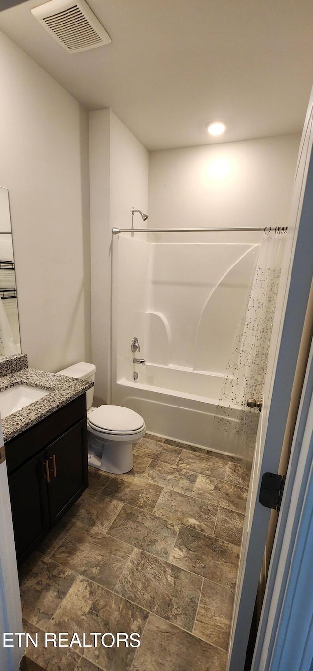 full bathroom with shower / bath combination with curtain, vanity, and toilet