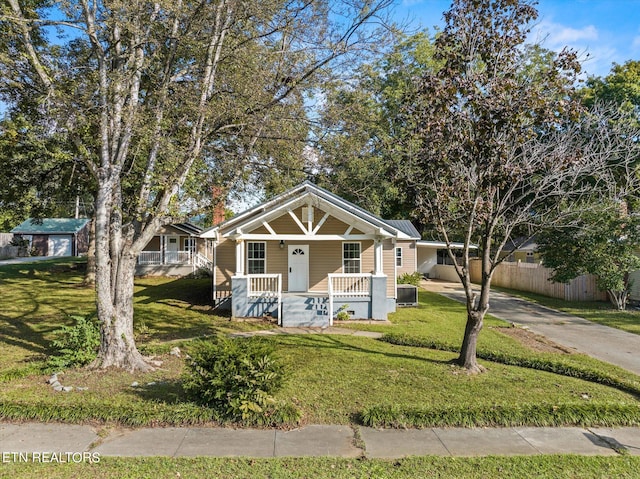 bungalow-style home featuring a front yard and covered porch