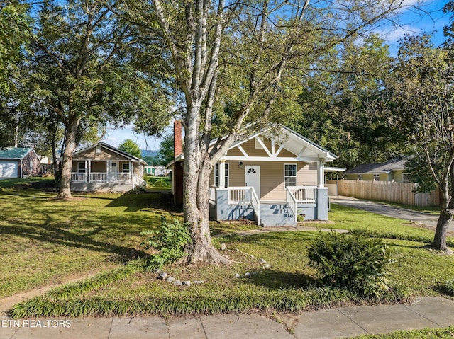 bungalow-style home with a porch and a front yard