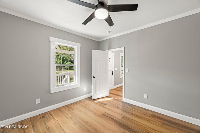 spare room featuring ornamental molding, light hardwood / wood-style flooring, and ceiling fan