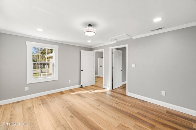 unfurnished bedroom with ornamental molding and hardwood / wood-style floors