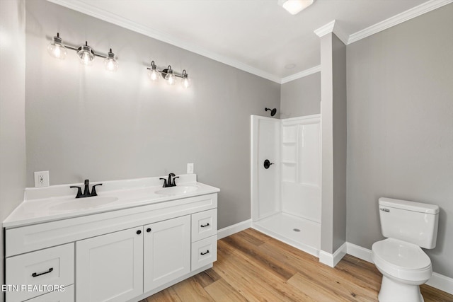 bathroom featuring a shower, toilet, crown molding, hardwood / wood-style floors, and vanity