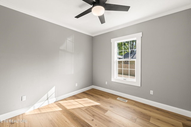 spare room with ornamental molding, light hardwood / wood-style flooring, and ceiling fan