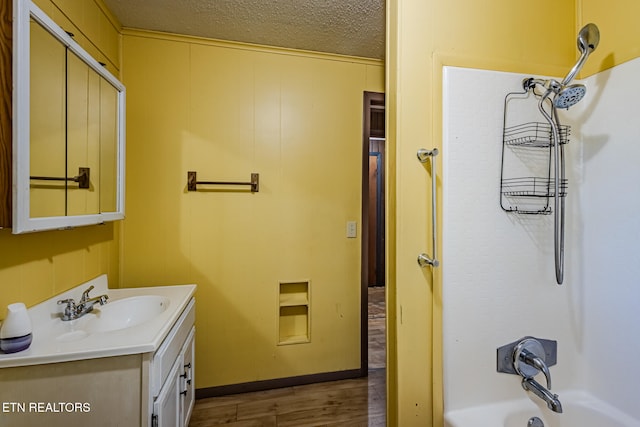 bathroom with vanity, wood-type flooring, and a textured ceiling