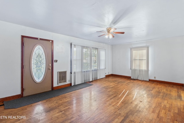 entrance foyer featuring wood-type flooring, ceiling fan, and a wealth of natural light