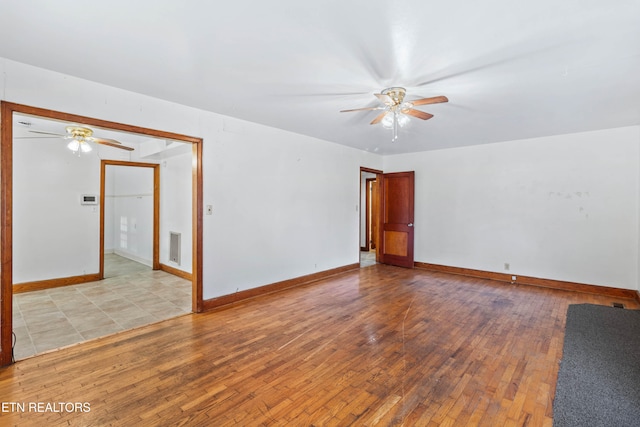 unfurnished room with ceiling fan and light wood-type flooring