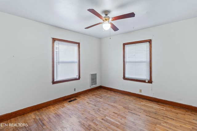 spare room with plenty of natural light, light hardwood / wood-style flooring, and ceiling fan