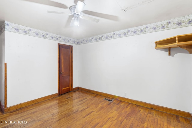 spare room with hardwood / wood-style floors and ceiling fan