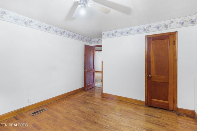 spare room with ceiling fan and light hardwood / wood-style flooring