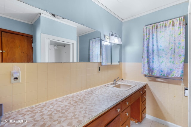 bathroom with tile patterned floors, crown molding, tile walls, and vanity