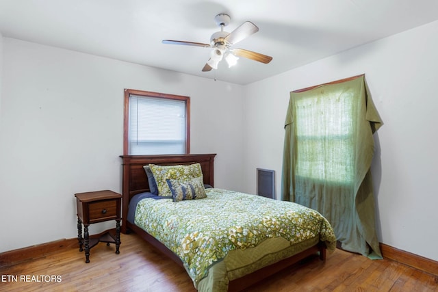 bedroom with ceiling fan and wood-type flooring