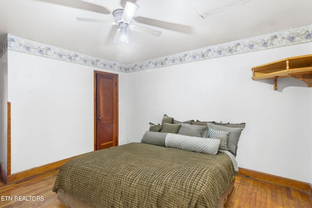 bedroom with ceiling fan and wood-type flooring