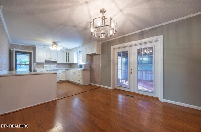 kitchen featuring french doors, decorative light fixtures, hardwood / wood-style floors, and white cabinets