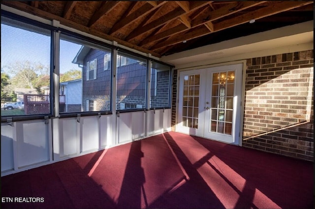 unfurnished sunroom with french doors