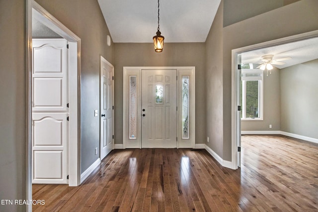 foyer entrance with ceiling fan and dark hardwood / wood-style flooring