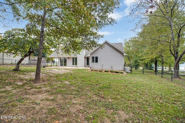 back of house with a lawn