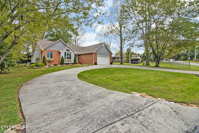 ranch-style house featuring a garage and a front lawn