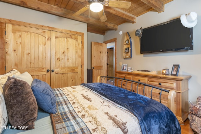 bedroom with wood ceiling, ceiling fan, beam ceiling, hardwood / wood-style flooring, and a closet