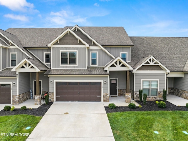 craftsman-style home with a garage and a front lawn