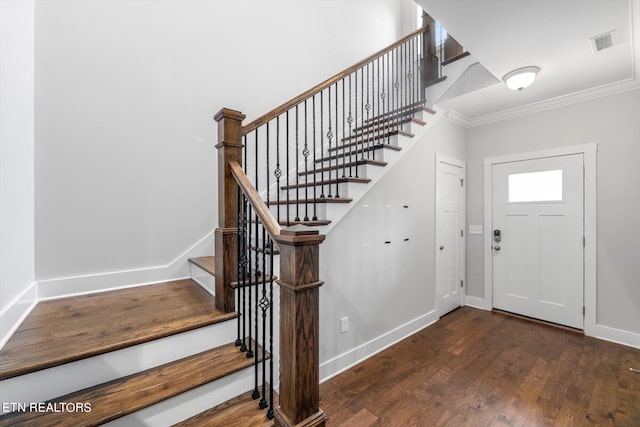 entryway featuring ornamental molding and dark wood-type flooring