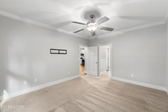 empty room with crown molding, ceiling fan, and light colored carpet