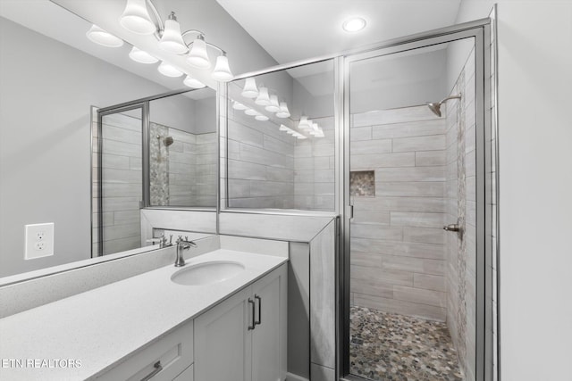 bathroom featuring an enclosed shower and vanity