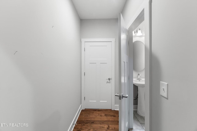 hallway with dark hardwood / wood-style flooring