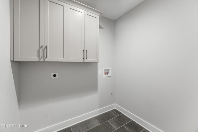 laundry area featuring washer hookup, hookup for an electric dryer, dark tile patterned flooring, and cabinets